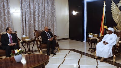Sudanese President Omar Al Bashir receives Egyptian Foreign Minister Sameh Shoukry, dcentre and intelligence chief Abbas Kamel in Khartoum on December 27, 2018. AFP