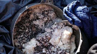 A container with beans and rice lies abandoned in a migrant boat. AP