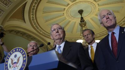 Senate majority leader Mitch McConnell with Sen Roger Wicker, Sen John Thune and Sen John Cornyn. Susan Walsh / AP