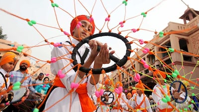 A Sikh boy performs 'Gatkha', a traditional form of martial arts during a religious procession on the eve of the 550th birth anniversary of Guru Nanak Dev, the first Sikh Guru and founder of Sikh faith, in Amritsar, India. REUTERS