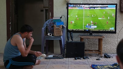 A Syrian fan watches the game in Hamouria, in the eastern Ghouta region. Abdulmonam / AFP Photo