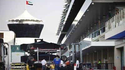 The season's final race at Yas Marina Circuit this weekend will decide a four-way contest, an unprecedented event for the sport. Above, F1 cars are unloaded from their trucks and rolled into the garages at the Yas Marina Circuit yesterday.