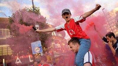 Arsenal fans celebrate outside the Emirates stadium in north London. AFP