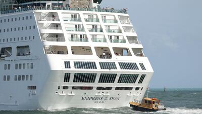 The Royal Caribbean cruise ship Empress of the Seas is guided out of PortMiami by a pilot boat, in Miami Beach, Florida. Lynne Sladky/AP