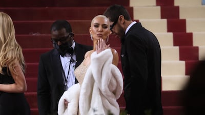 The reality TV star accessorised the 1962 dress with a faux fur coat. Reuters