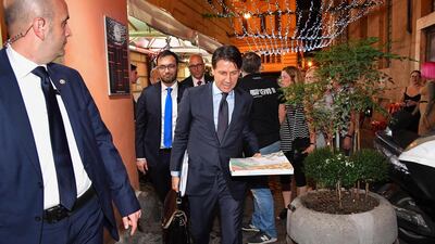 Italian Premier designate, Giuseppe Conte, takes a pizza before returning to his home, Rome, Italy, 25 May 2018. Rating agency Moody's may cut Italy's credit rating over concerns the new government may reverse earlier reforms. EPA