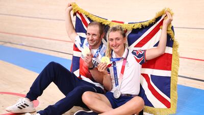 Men's Keirin gold medallist Jason Kenny and his wife Laura of Britain pose with their medals and a British flag.