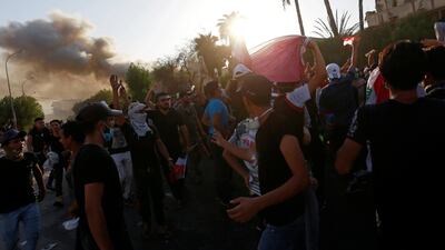 People gather during a protest near the building of the government office in Basra. REUTERS
