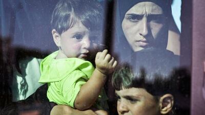 A migrant girl with children looks on after disembarking from a Greek government-chartered ‘Eleftherios Venizelos’ ferry at the port of Piraeus in Athens. Another 2,500 migrants arrived aboard the ferry to Piraeus from the island of Lesbos, as Greece this year has been overwhelmed by record numbers of migrants arriving on its eastern Aegean islands, with more than 160,000 landing since January. Louisa Gouliamaki / AFP