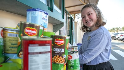 Marlee Mapstone, who is in the seventh year, takes part in the aid collection drive. Victor Besa / The National