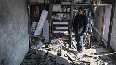 A man inspects a damaged house after several rockets land at Khair Khana, north west of Kabul. A series of loud explosions shook central Kabul on November 21, including several rockets that landed near the heavily fortified Green Zone where many embassies and international firms are based, officials said. AFP