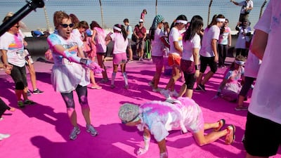 Participants crawl past the finish line to be met with more pink powder. Clint McLean for The National