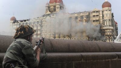 An Indian soldier aiming his weapon towards The Taj Mahal Hotel in Mumbai during the siege in November 2008. Pedro Ugarte / AFP Photo