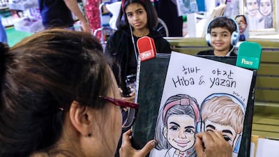 A South Korean caricature artist busy at work in Global Village