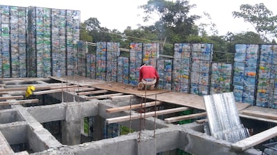 Construction of a house at Plastic Bottle Village. Courtesy Robert Bezeau