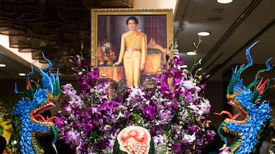 A painting depicting Thailand's Queen Sirikit adorns an elaborate fruit and vegetable decoration during a fruit and vegetable carving competition in Bangkok. Robert Schmidt / AFP