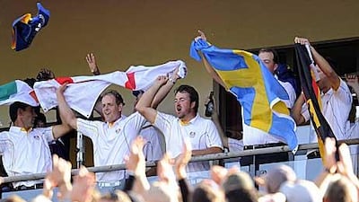 Europe Ryder Cup players Graeme McDowell, third from left, celebrates with teammates Padraig Harrington, Luke Donald and Peter Hanson (second right) on the balcony of the clubhouse at Celtic Manor golf course in Newport, Wales.