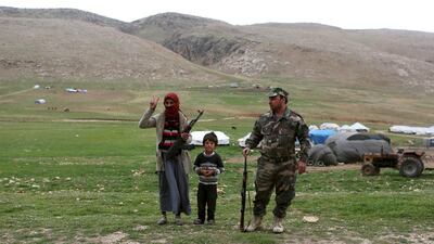 A displaced Yazidi family at their tent village. Asmaa Waguih / Reuters