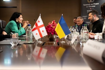 President Salome Zourabichvili of Georgia, left, and Ukrainian President Volodymyr Zelenskyy, right, at a bilateral meeting during the peace summit. Reuters