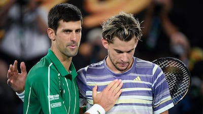 Novak Djokovic commiserates Dominic Thiem after the match. AP