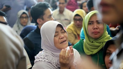 A relative of passengers prays as she and others wait for news on the Lion Air plane. AP Photo