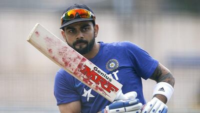 India cricket team captain Virat Kohli watches his shot while batting in the nets during a training camp at the National Cricket Academy in Bangalore, India, Saturday, July 2, 2016. Aijaz Rahi / AP Photo