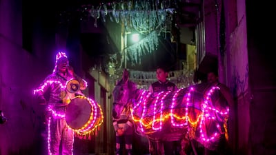 Mohammed El-Dahshan, 38-year-old "Mesaharati," or dawn caller, accompanies his donkey wrapped with colored led lights to wake Muslims up for a meal before sunrise, during the Islamic holy month of Ramadan, in the Delta city of Dikernis, about 93 miles (150 km) North of Cairo, Egypt early Wednesday, April 12, 2023. Each night, El-Dahshan, sets out after midnight with his donkey banging his drum, chanting traditional religious phrases and calling out on residents by name to wake them in time for the vital pre-dawn meal known as "Suhour". (AP Photo / Amr Nabil)