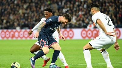 Messi fights for the ball with Lille's Jonathan David (L) and Zeki Celik. AFP