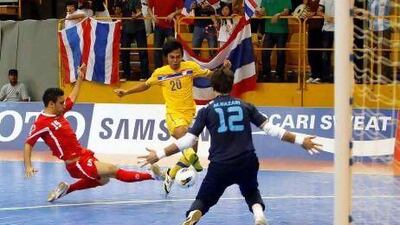 Iran's defense could not stop Thailand's Jirawat Sornwichian, left, from scoring. Thailand overcame the tournament favourites 5-4.