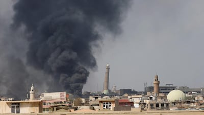 Smoke rises from clashes near Mosul’s Al Habda minaret at the Grand Mosque, where ISIL leader Abu Bakr Al Baghdadi declared his caliphate in 2014. Iraqi forces battle to drive out Islamic state militants from the western part of Mosul, Iraq. Youssef Boudlal / Reuters / March 17, 2017