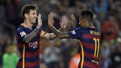 Lionel Messi, left, scored twice and Neymar once as Barcelona beat Levante at Camp Nou on Sunday night. Lluis Gene / AFP