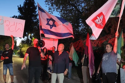 Right-wing activists protest outside the home of Naza co-director Rachel Szor's family, in Savyon, central Israel. AFP