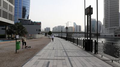 The canalside in Business Bay is a favourite place for Pooja Singh to take her two dogs for a walk. Pawan Singh / The National