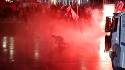 A fleeing protester falls after he was hit by a police water cannon during a rally against Turkey's Prime Minister Tayyip Erdogan in Ankara. Umit Bektas / Reuters