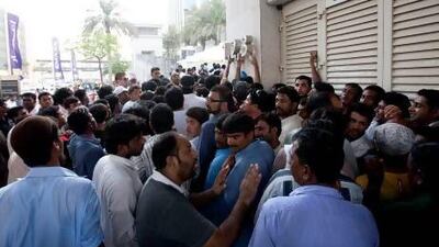 In the past, people have been paid to queue up to collect tokens for a chance to buy property. Mike Young / The National