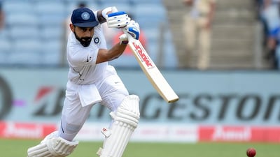 India captain Virat Kohli plays a shot on the second day of the second Test cricket match between India and South Africa in Pune on Friday. AFP
