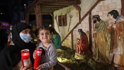 A woman shows her child the Christmas tree lighting ceremony in Beirut's Gemmayzeh neighbourhood, on December 4. AFP