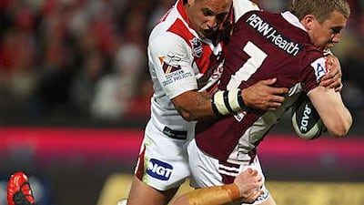 Manly's Trent Hodkinson is halted by the Dragons defence during their 32-10 defeat at WIN Jubilee Oval last night.