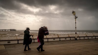 People brave wind and rain on Blackpool's North Pier as heavy clouds in the west mark the approach of Storm Kathleen to the UK. Getty Images