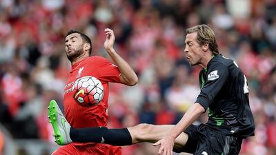 Stoke City’s Peter Crouch (R) in action with Liverpool’s Kevin Stewart (L) during the Premier League match between Liverpool and Stoke City at the Anfield, Manchester, Britain, 10 April 2016. EPA/PETER POWELL