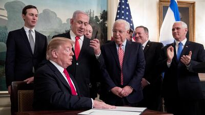 Prime Minister of Israel Benjamin Netanyahu (Back C) holds up the pen used by US President Donald J. Trump (Front C) to sign an order recognising Golan Heights as Israeli territory. EPA