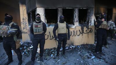 Iraqi security forces gather at the entrance of the US embassy. AFP