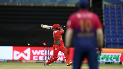 Oman's Hassnain Shah is bowled on Monday