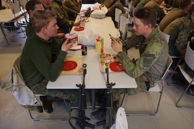 Finnish conscript soldiers eat snacks in a cafeteria. The country shares a 1,340km border with Russia. Getty Images