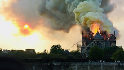 Flames and smoke are seen billowing from the roof at Notre-Dame Cathedral in Paris on April 15, 2019. AFP