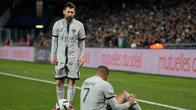 PSG's Lionel Messi stands next to injured teammate Kylian Mbappe. AP Photo