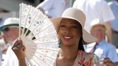 A spectator uses a fan to keep cool on the second day of the Test match between England and Ireland at Lord's cricket ground in London. AP