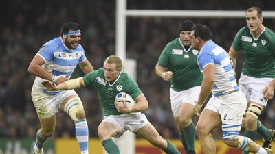 Ireland centre Keith Earls runs with the ball next to Argentina prop Ramiro Herrera. Damien Meyer / AFP