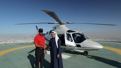 Tiger Woods is welcomed by His Excellency Saeed Hareb, the Secretary General of Dubai Sports Council, as he revisits the Burj Al Arab helipad. David Cannon / Getty Images for Falcon