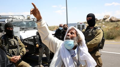 A Palestinian protester argues with Israeli security forces as he protests against Israeli settlement building activities on their land in the village of West Bank Yatta, near Hebron. EPA